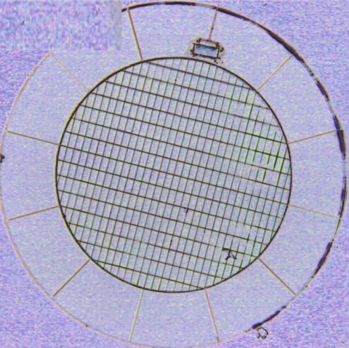 Picture of a polarization sensitive bolometer. This a 217 GHz module, The temperature sensor is at the an edge  of the absorbing grid